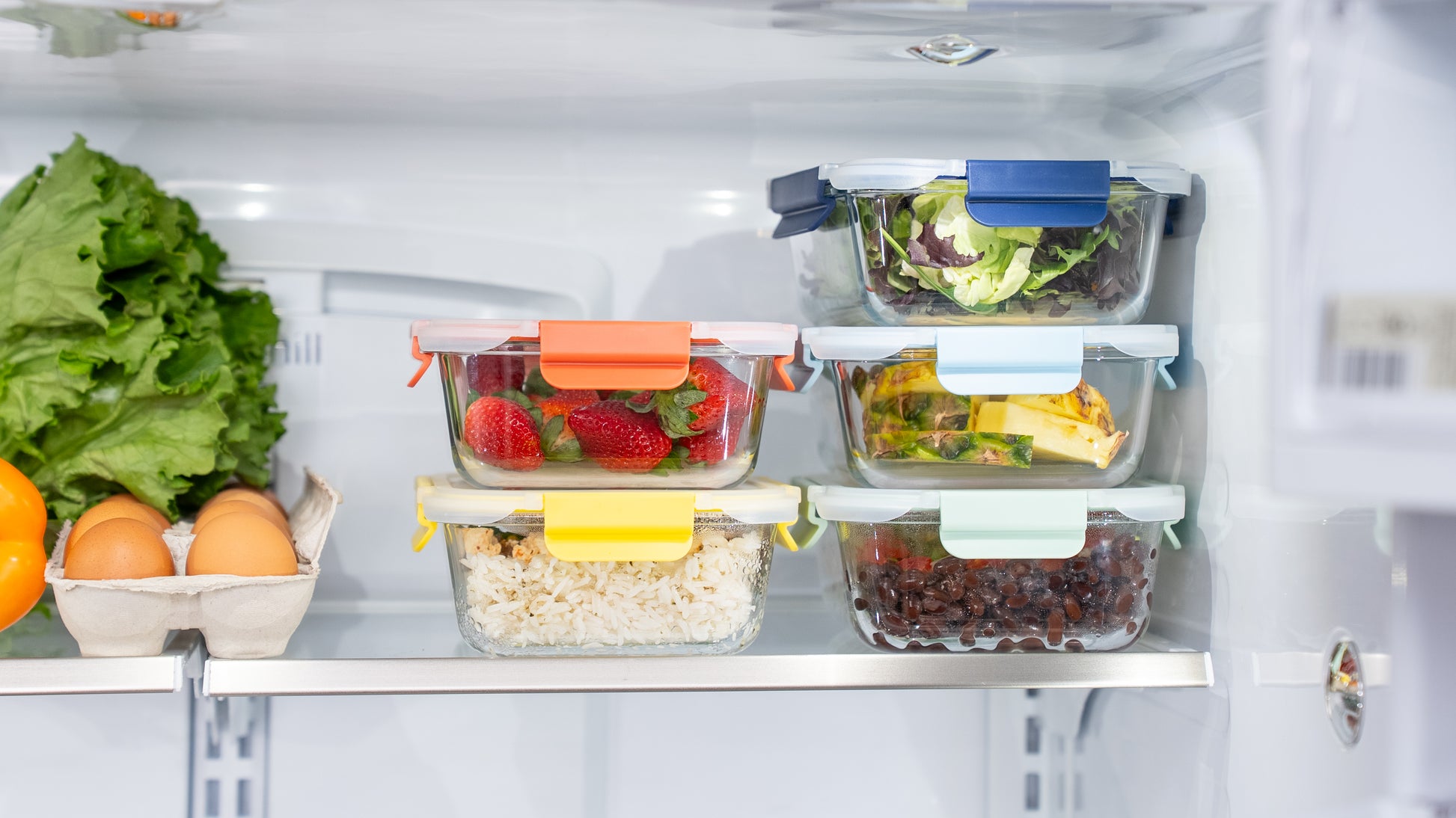 Organized meal prep using Ceywa glass food storage containers with colorful lids in refrigerator