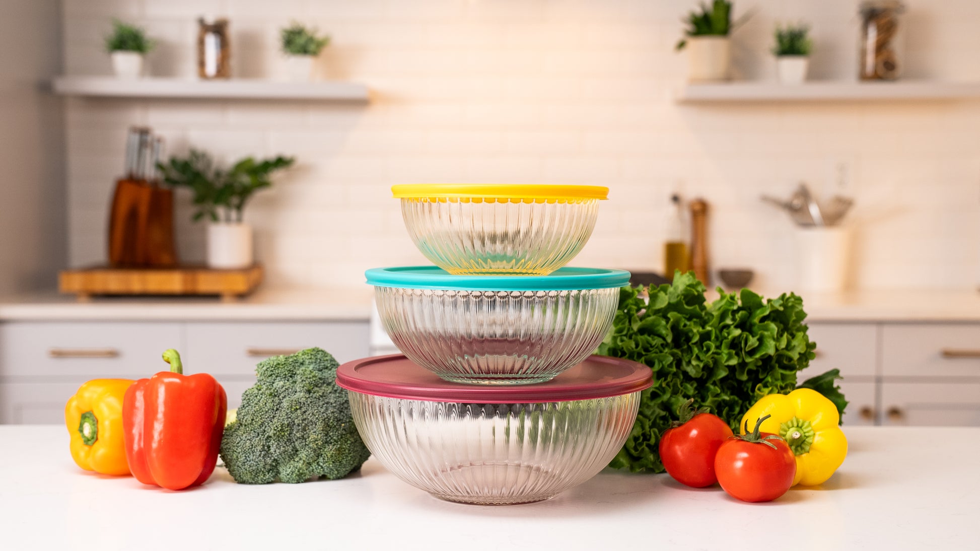 Ceywa clear glass mixing bowls 3 Piecet Set with colorful airtight lids on kitchen countertop with vegetables and herbs