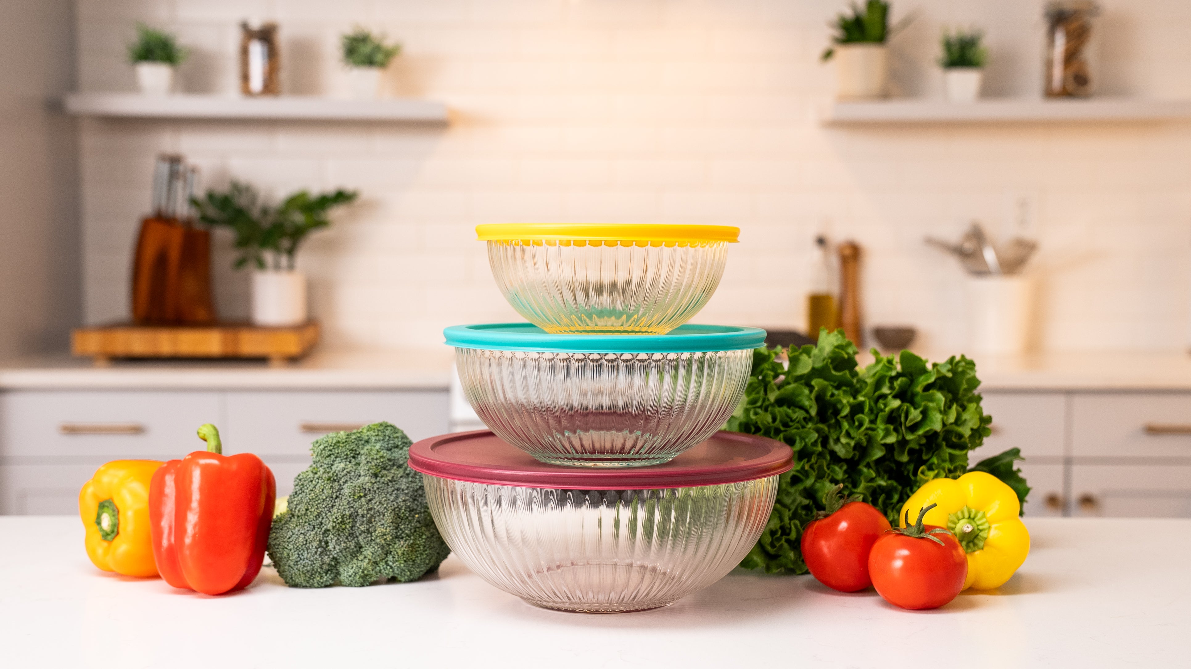 Ceywa clear glass mixing bowls 3 Piecet Set with colorful airtight lids on kitchen countertop with vegetables and herbs